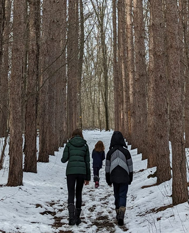 Kalamazoo College students on a trail at the Lillian Anderson Arboretum.