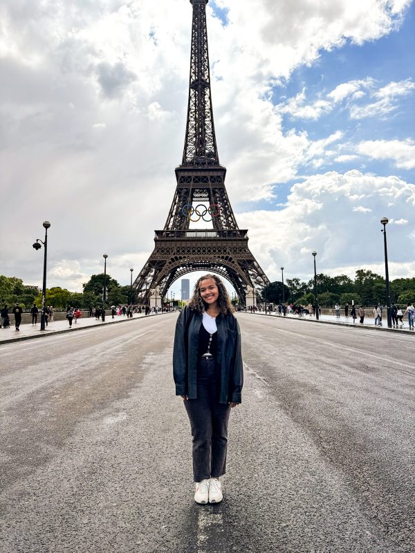 Maya Hester, class of 2025, posing in front of the Eiffel Tower in Paris, France.