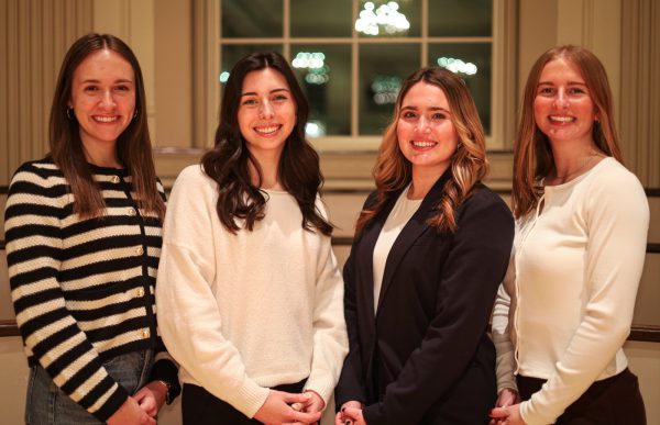 The Professional Women's Club leadership board, consisting of four women students, marks International Women's Day