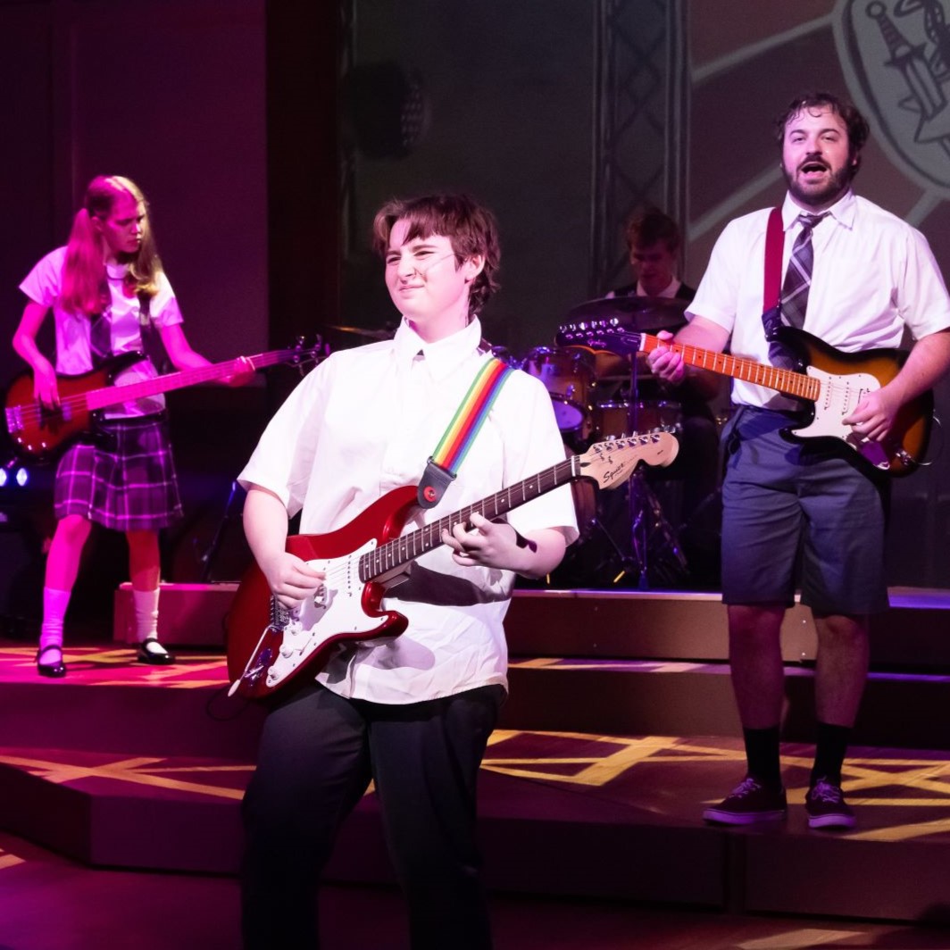 School of Rock actors rehearse while playing instruments